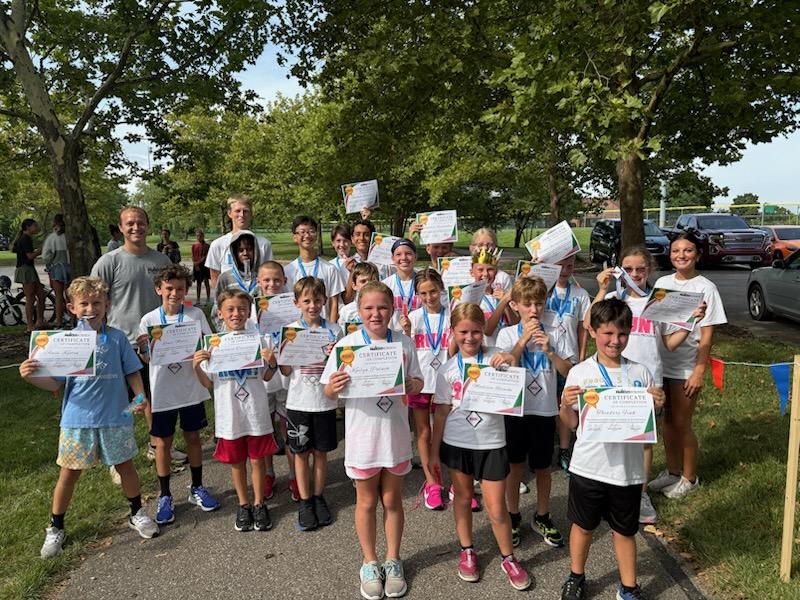 A photo of children with awards certificates.